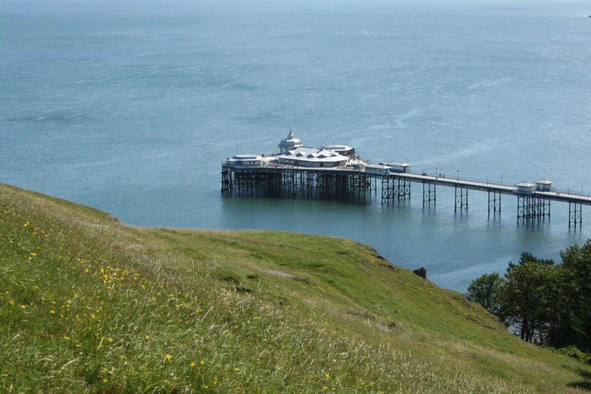Llandudno Pier extending into the sea on a calm day.